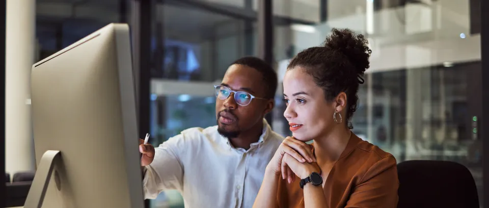 Two people working at a computer