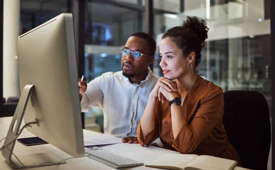 Two people working at a computer