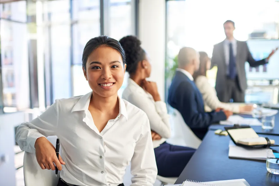Woman in a business meeting, facing the camera and smiling