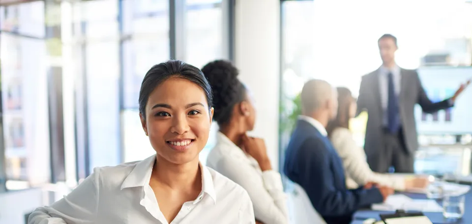 Woman in a business meeting, facing the camera and smiling