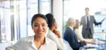 Woman in a business meeting, facing the camera and smiling