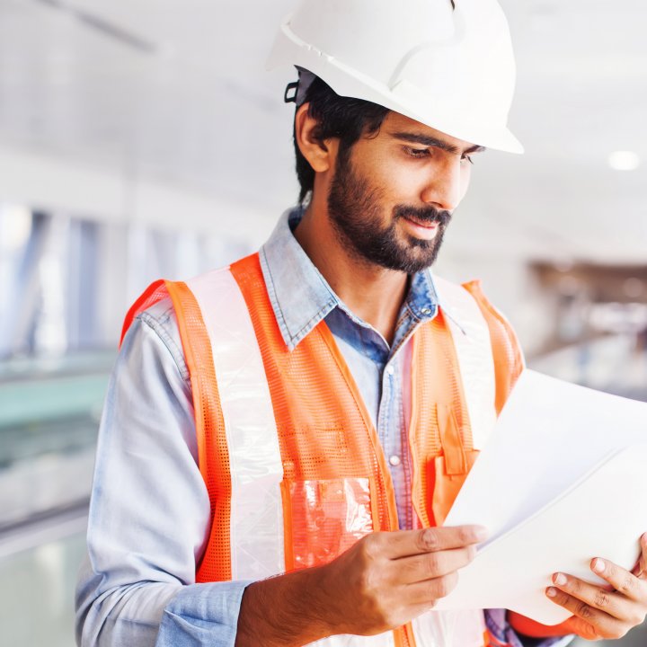 Trade person looking at plans-Close