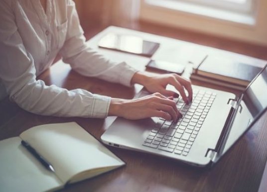 person typing on laptop