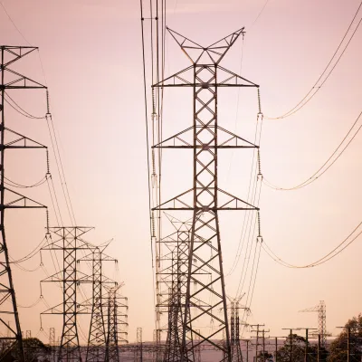 Power lines against sunset